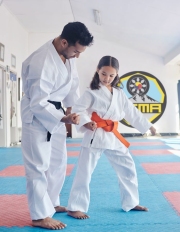 Theres no cant in our karate class. Shot of a young man and cute little girl practicing karate in a studio.